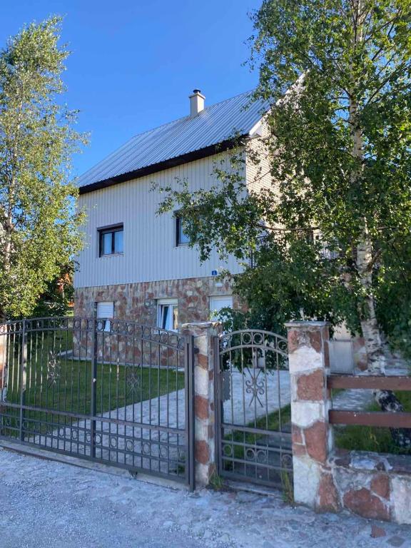 an old stone building with a gate in front of it at Apartment Nikola R in Žabljak