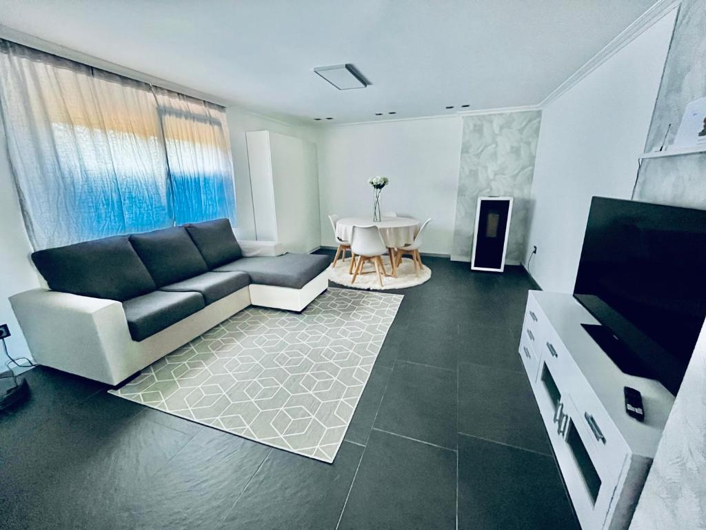 a living room with a couch and a table at Casa do Prado in Pontevedra
