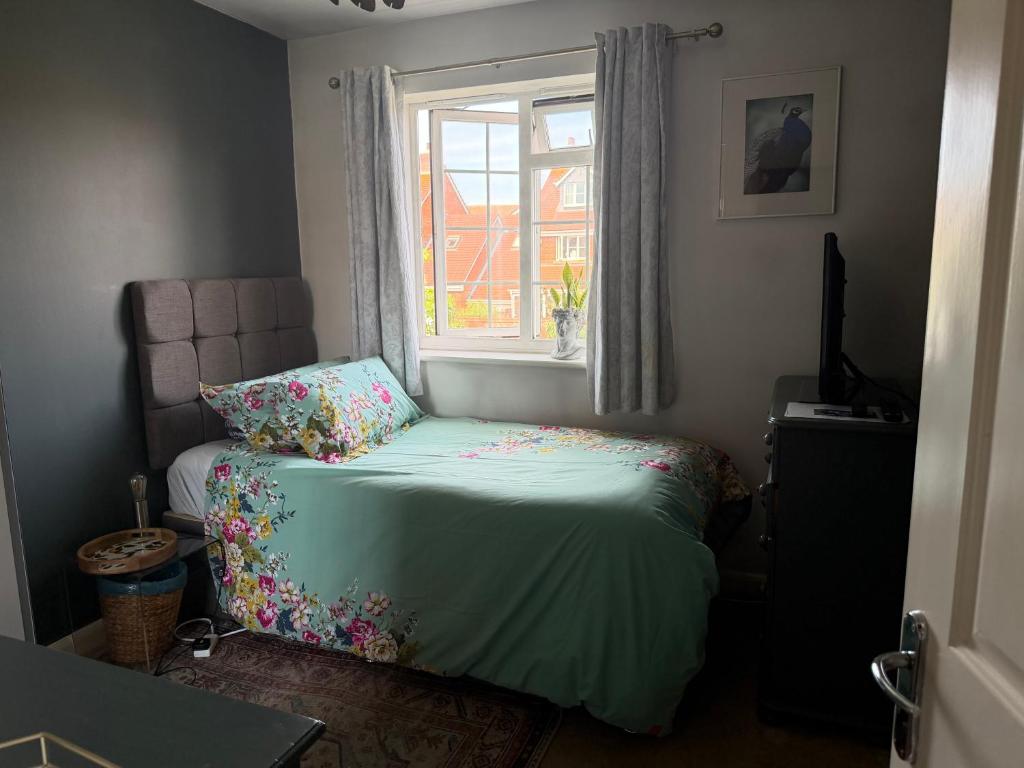 a small bedroom with a bed and a window at Eastbourne in Pevensey