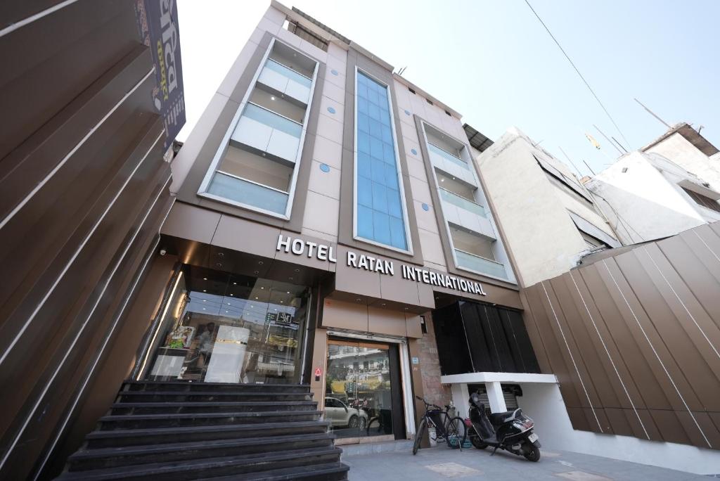 a building with a stairway in front of a store at Hotel Ratan International in Raipur