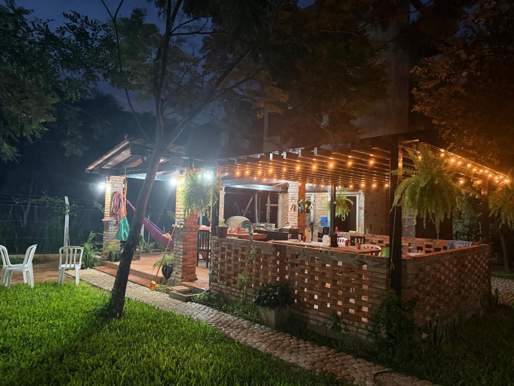 a house with lights on the outside at night at Rancho Don Sina in Caacupé