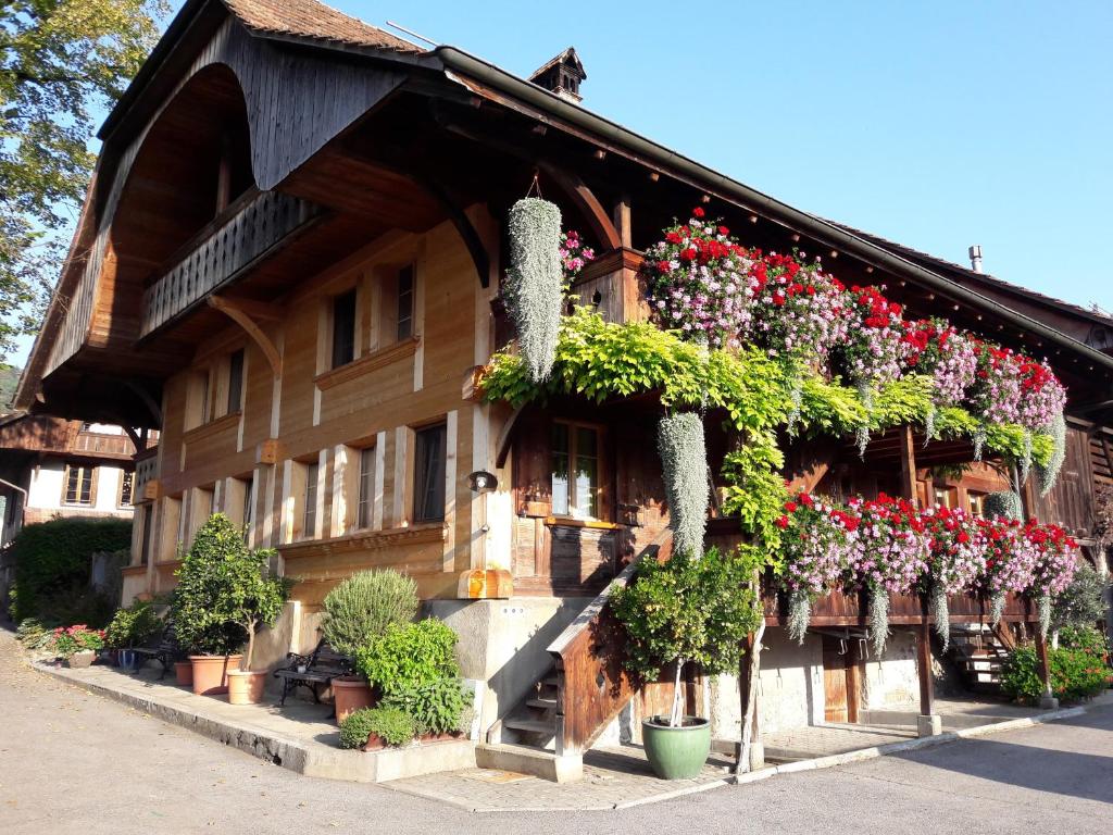 a building with lots of plants and flowers on it at bed and breakfast Liechti in Wattenwil
