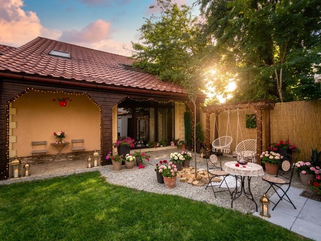 a backyard with a patio with a table and chairs at Villa DeaDorata in Oradea