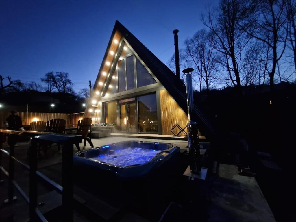 a house with a jacuzzi tub in front of it at AVA Chalet with Jacuzzi in Sinaia