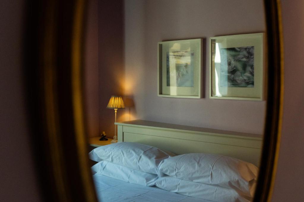 a bedroom with a bed and two pictures on the wall at Casa PETRONILA in Lerma