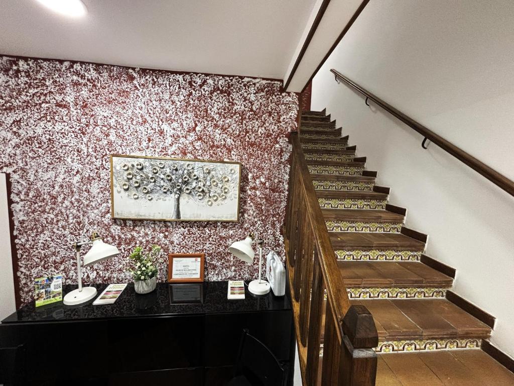 a staircase in a building with a painting on the wall at La Arbolada in Navacerrada