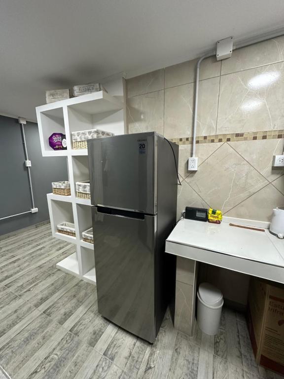 a kitchen with a stainless steel refrigerator and a counter at Lo de jota in Ramallo