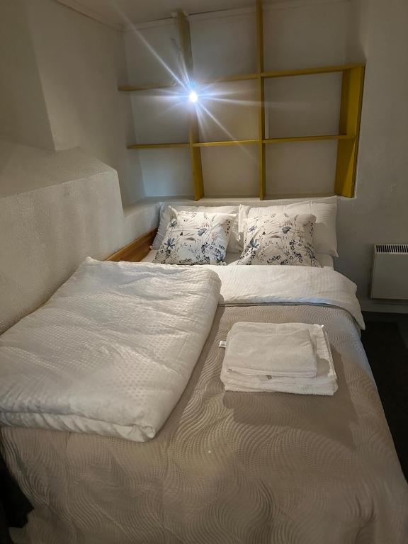 a pair of beds in a room with a light at Fantastic Apartment Tromsø Two in Tromsø