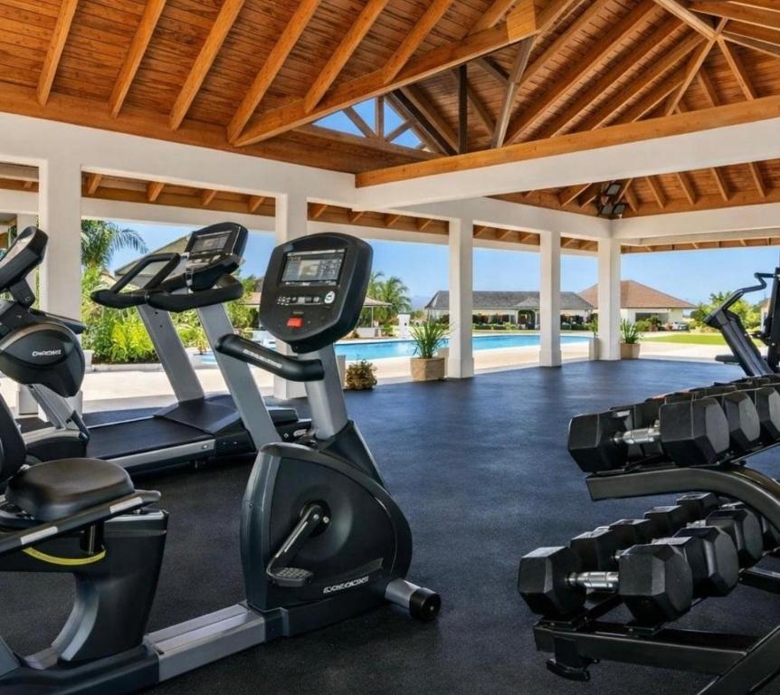 a gym with cardio equipment in a villa at Willis staycation in Sandy Bay