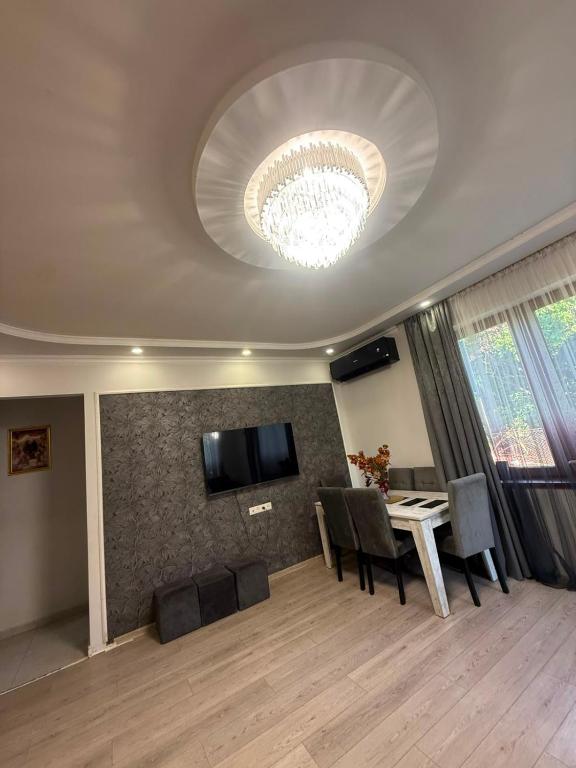 a living room with a dining table and a chandelier at home 4 room in Yerevan