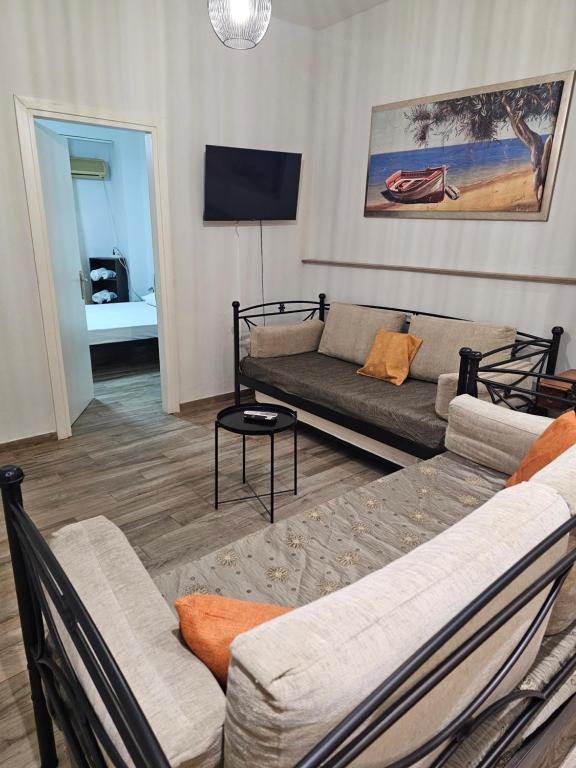 a living room with a couch and a tv at Aspa's house in Athens