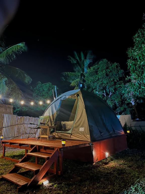 a tent sitting on a picnic table at night at Ayira Campsite in Vilankulo Airport