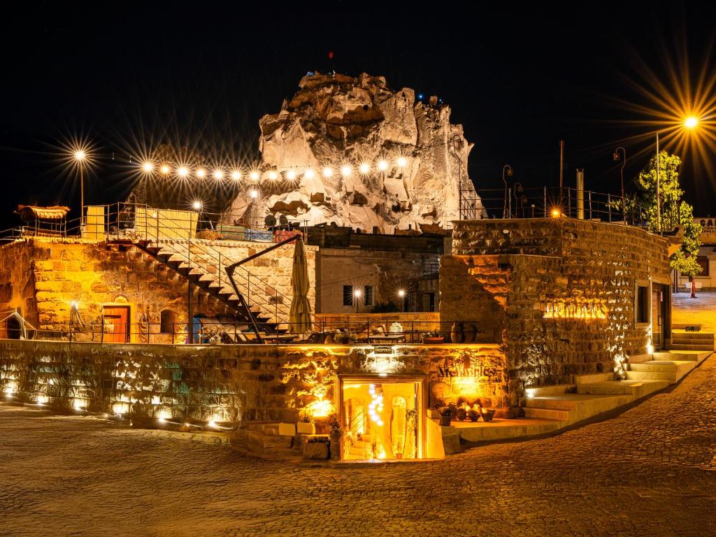 a castle lit up at night with lights at Memories Cave House in Uçhisar
