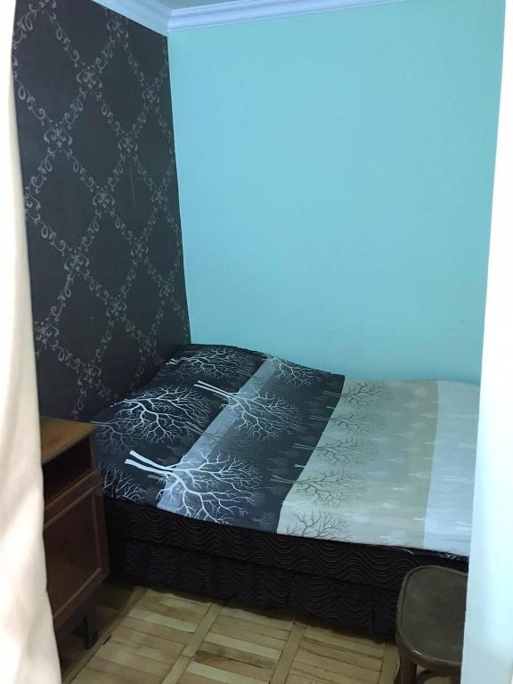 a bedroom with a bed with a black and white comforter at Jermuk in Jermuk