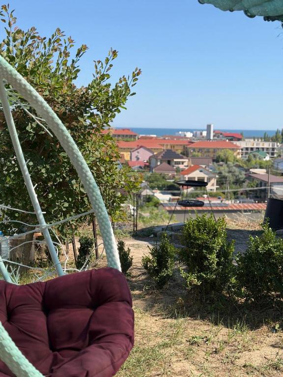 a chair in a yard with a view of a city at Sea Panorama in Karolino-Buhaz