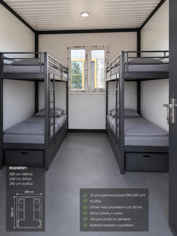two bunk beds in a room with a window at Chatka U Rybičky in Babice