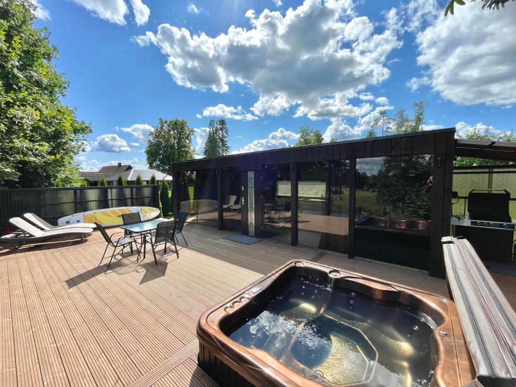 a hot tub on the deck of a house at KotkaPesa in Vihtra