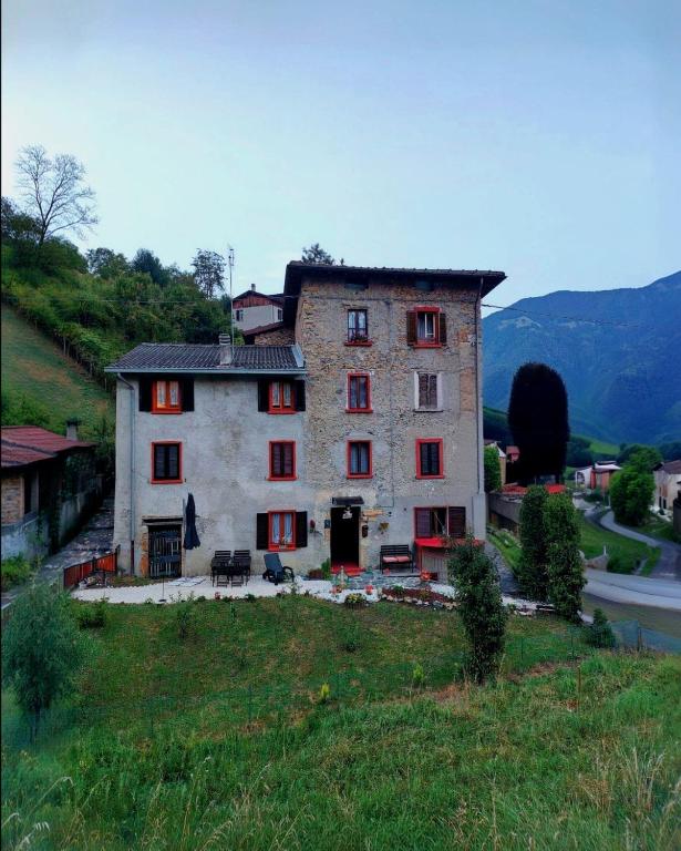 a large stone house on a hill in a field at La Dimora di Beatrice in Santa Brigida