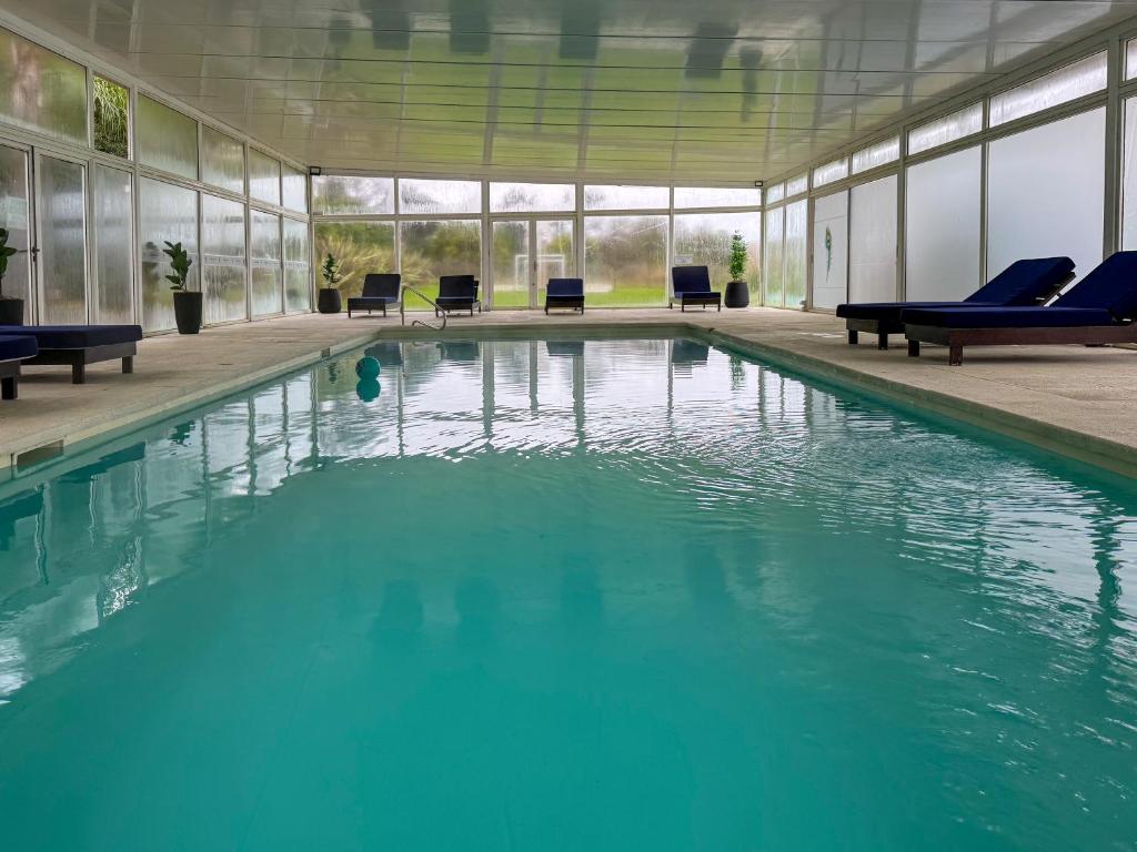 a large pool with blue water in a building at Skyblue Park in Piriápolis