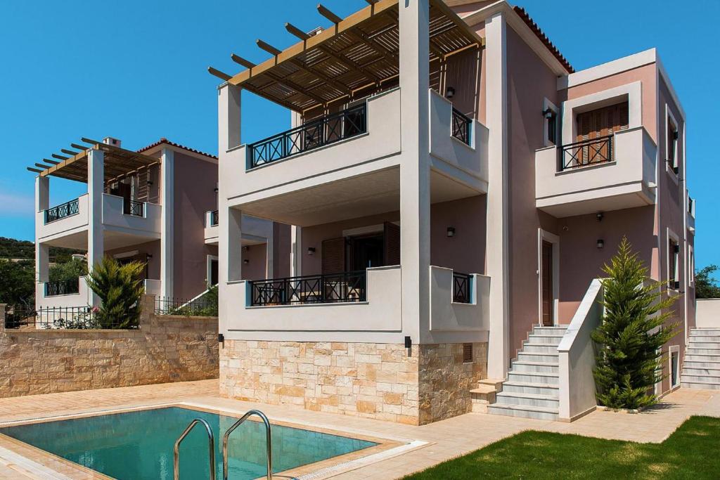 a house with a swimming pool in front of it at Cottage in Adele in Ádhele