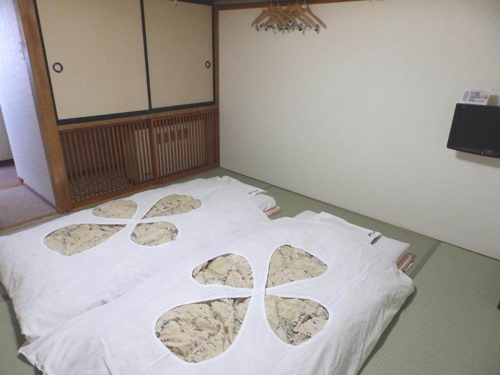 Postel nebo postele na pokoji v ubytování Hotel Tagawa
