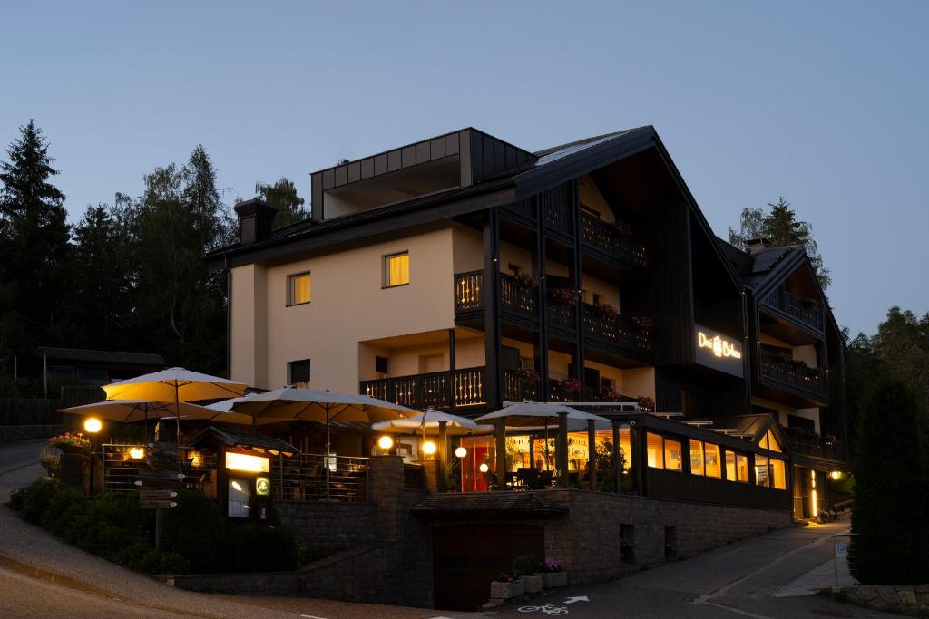 a large building with umbrellas in front of it at Drei Birken in Soprabolzano