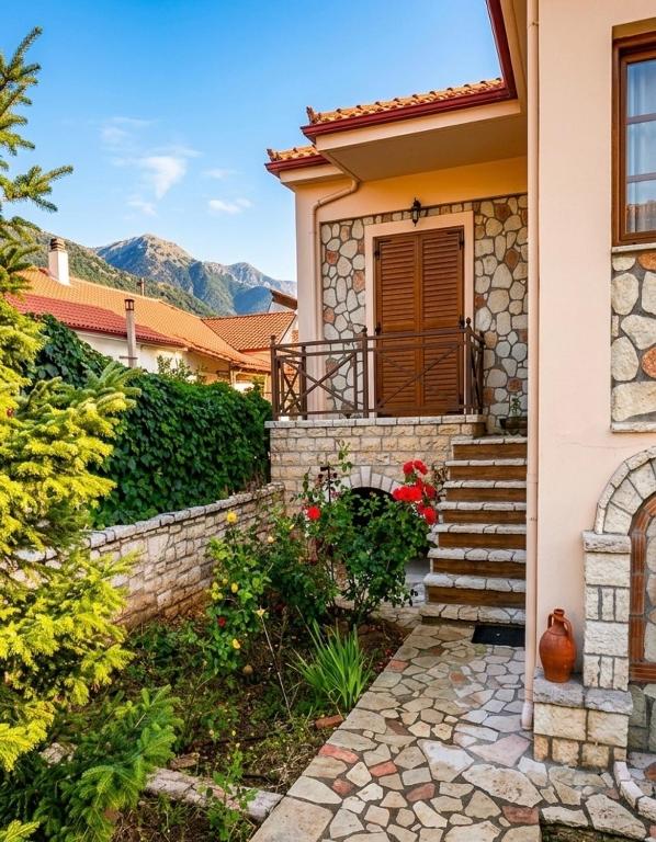 a house with a stone staircase leading to the front door at Dreamcatcher Maisonette No.2 in Kalavrita
