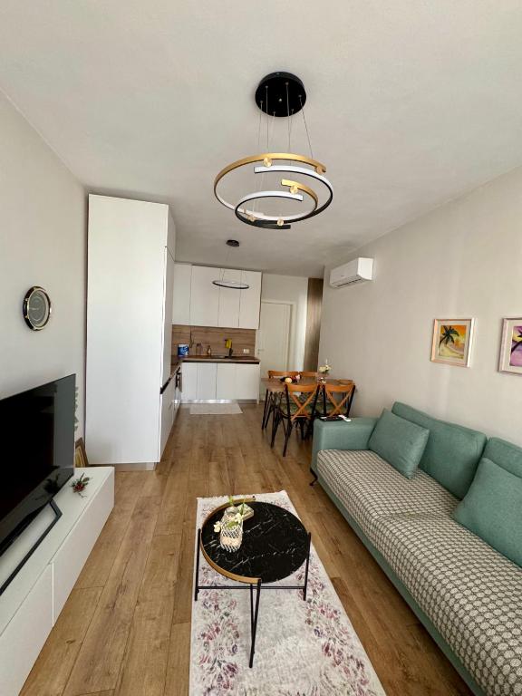 a living room with a couch and a table at Erli's Apartment in Golem