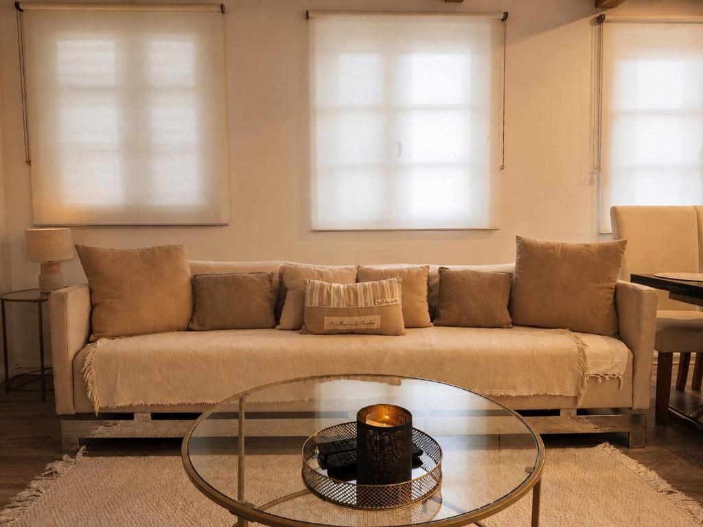 a living room with a couch and a glass table at Sweet Home & Spa in Erstein
