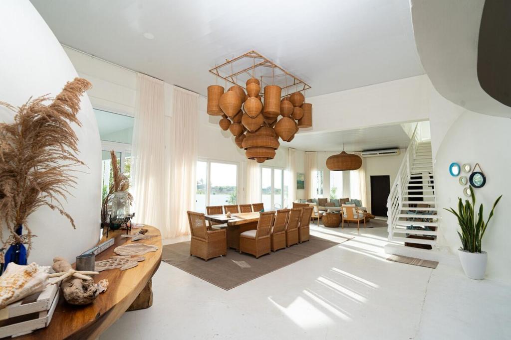 a large living room with a table and chairs at Casa Sofia 19 Guests, Steps From The Sea in Tela