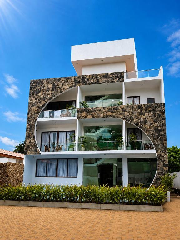 a large white building with a stone facade at Pearl Diamond Resort in Trincomalee