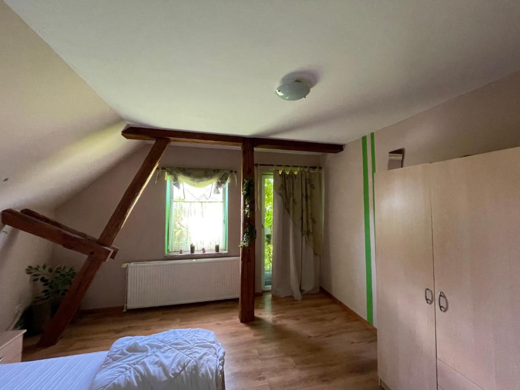 an attic room with a bed and a window at Zimmervermietung Tramm 