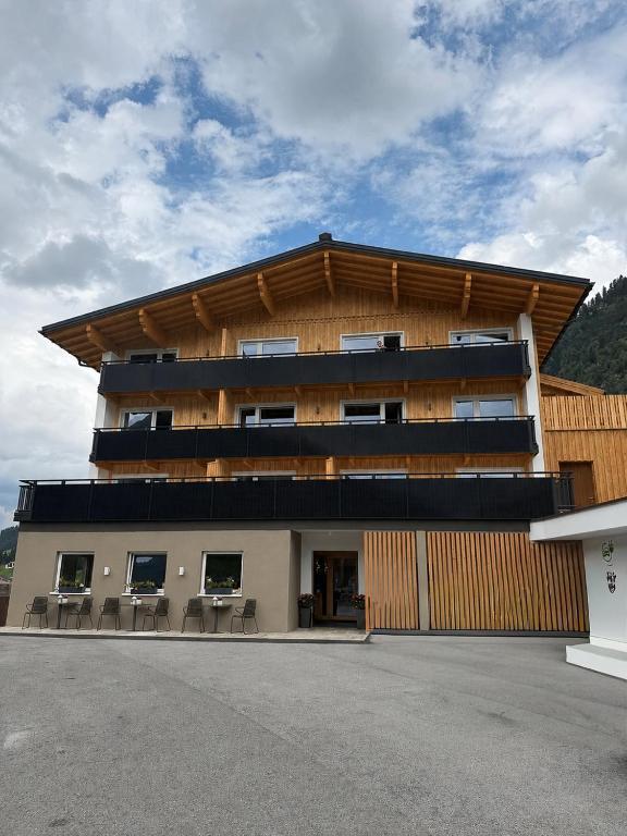 a building with tables and chairs in a parking lot at Soldanella in Lech am Arlberg