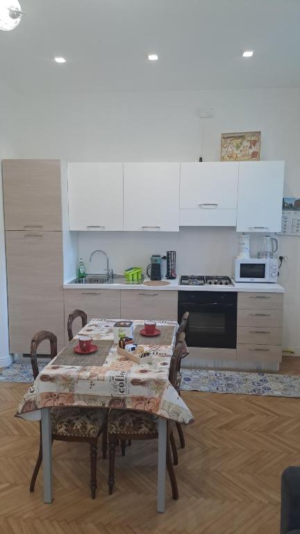 a kitchen with a table with chairs and a stove at B&B MAST Apartment Suite in San Pellegrino Terme