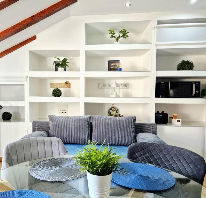 a living room with couches and a glass table at Apartments Sandra in the historical center of the city in Supetar