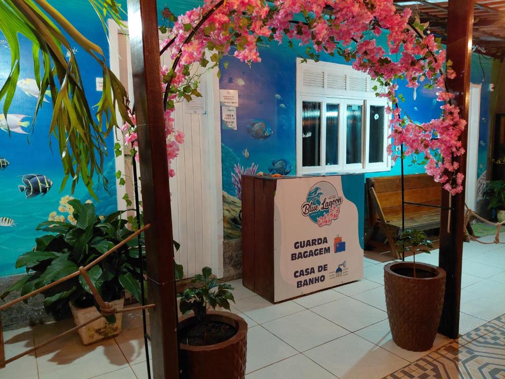 a room with plants and a sign that says garden bureau get a stamp at Hostel e Pousada Blue Lagoon in Abraão