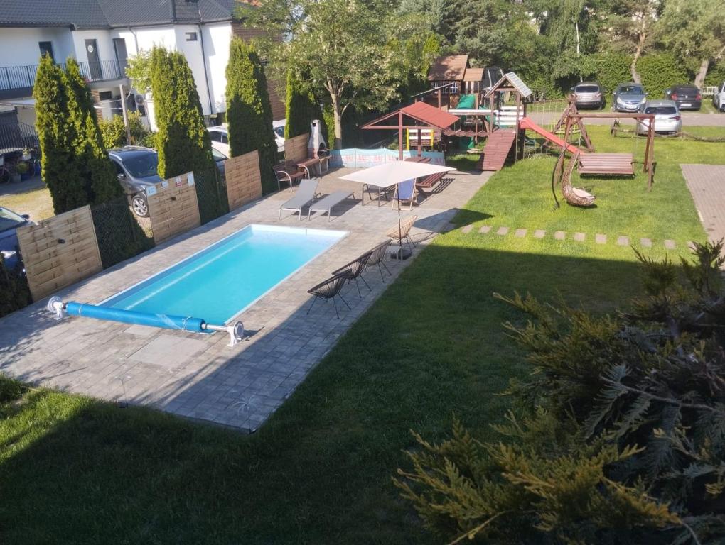 a swimming pool in a yard with a playground at Best in Karwia