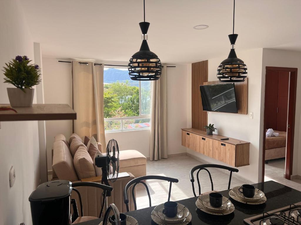 a living room with a table and chairs and a couch at Refugio Tenerife San Gil in San Gil