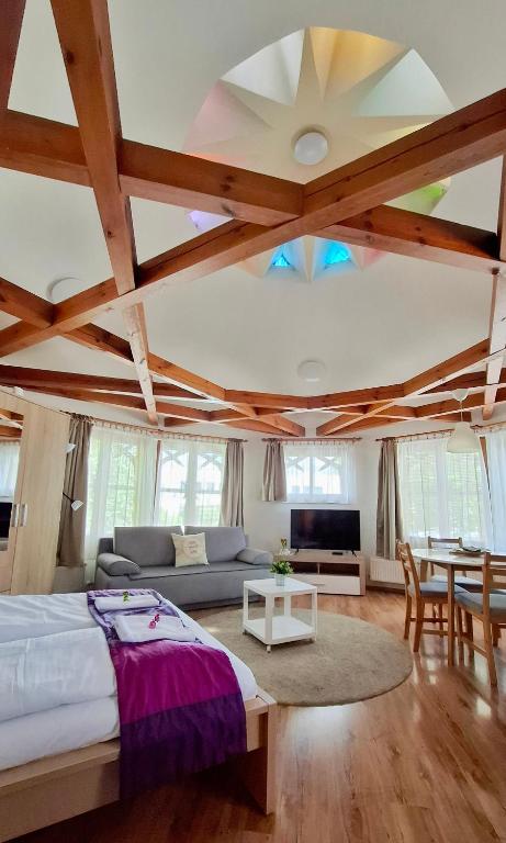 a bedroom with a bed and a couch and a table at Danubia Apartman in Esztergom