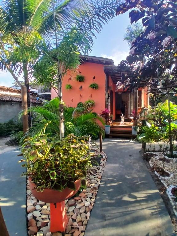 a courtyard of a house with potted plants at Espaço Casa Palmar in Barra Grande