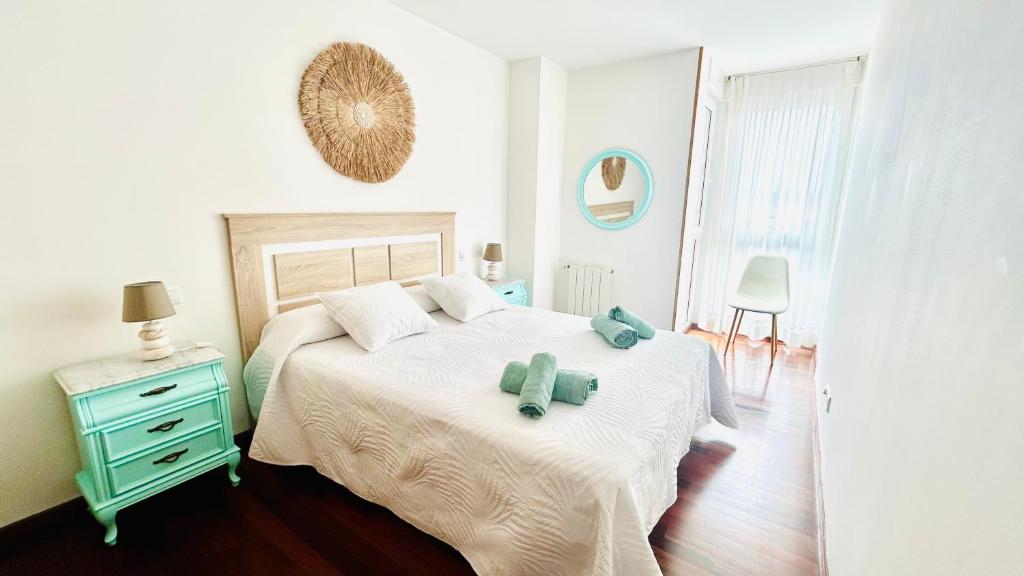 a bedroom with a bed with two teddy bears on it at Ocean Suances in Suances