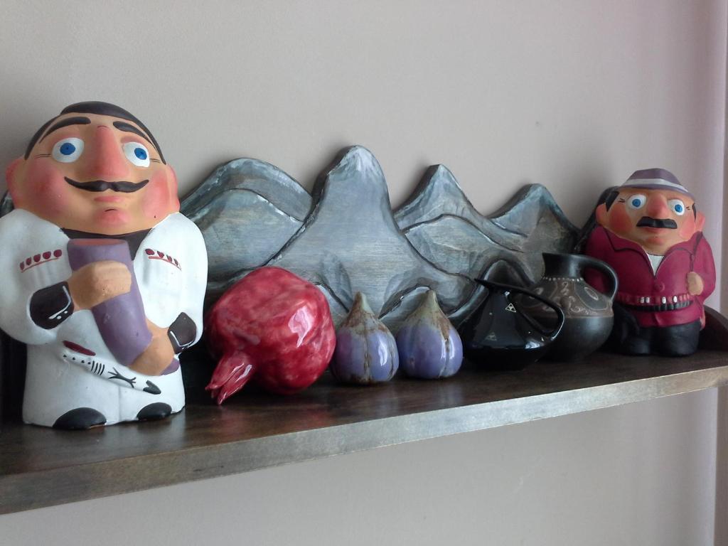 a shelf with figurines and other items on it at Apartment Na Lidzava Beach in Pizunda