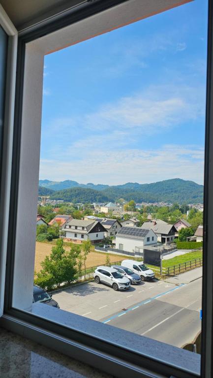 a view from a window of a parking lot at Tang Guesthouse in Medvode