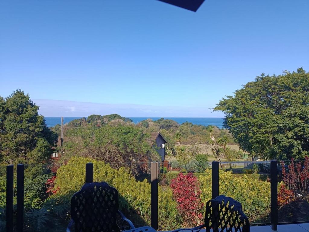 a view of the ocean from the balcony of a house at The Tee Box in Southbroom
