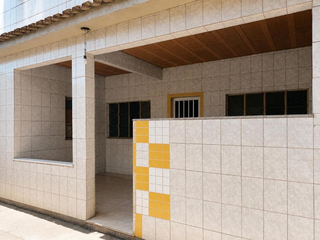 a facade of a building with tiles on it at Villa Santa Terezinha in Mesquita