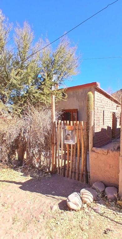 a wooden fence in front of a house at Pacha Wasi in Humahuaca