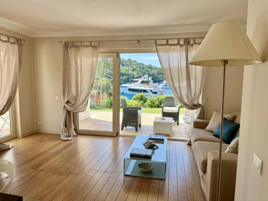 a living room with a couch and a table at Poltu Quatu House in Porto Cervo