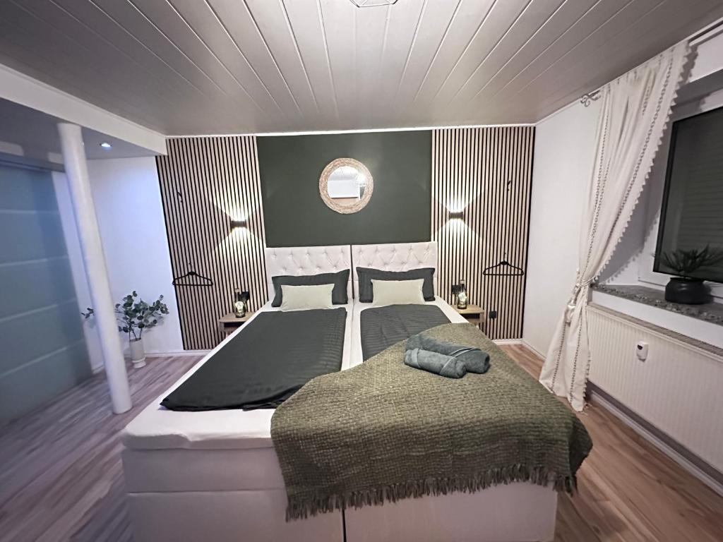 a bedroom with a large bed and a television at Suite House - Magnolia - Oak - Sage in Bayreuth