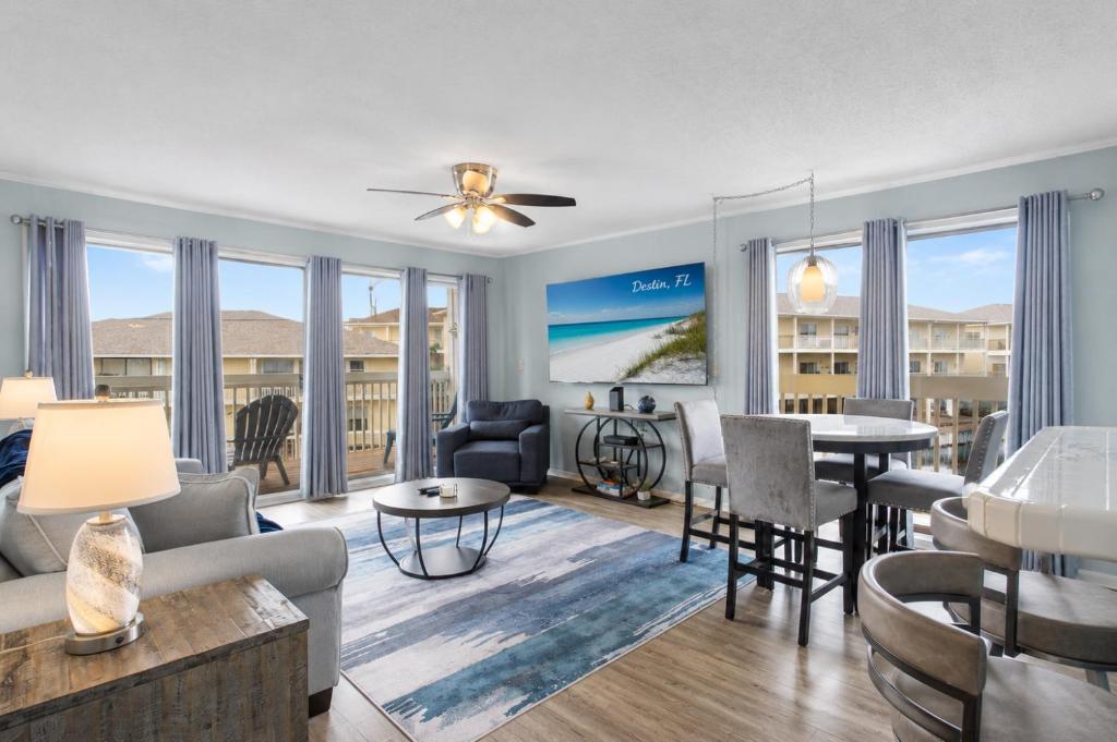 a living room with a couch and a table at Waterfront Summer Vacay Free Private Beach Chairs & Umbrella Sleeps 5 in Destin
