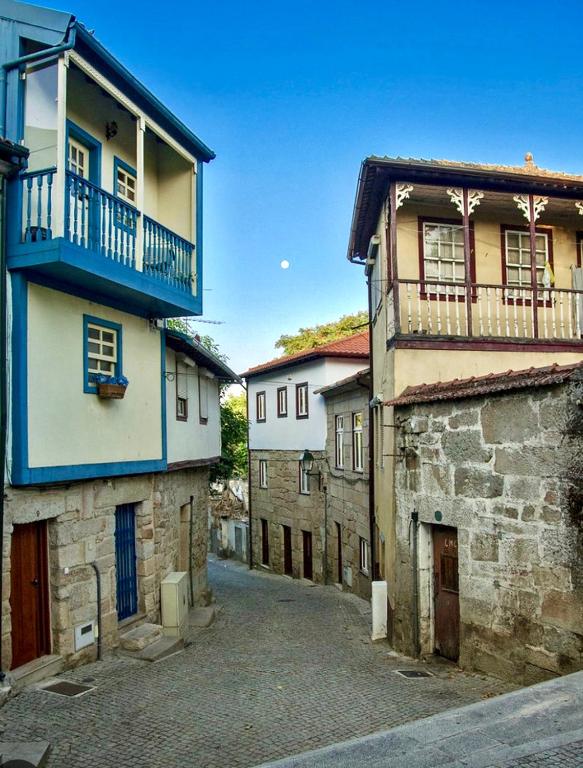 an alley in an old town with buildings at Charming Casa Azul - Stay in Historic Chaves in Chaves